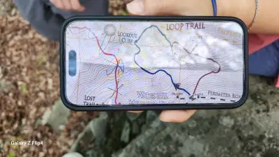 The hiking trail map displayed on a phone showing countours and a loop trail