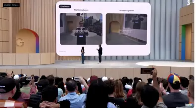 Two people on stage using Google XR glasses to communicate