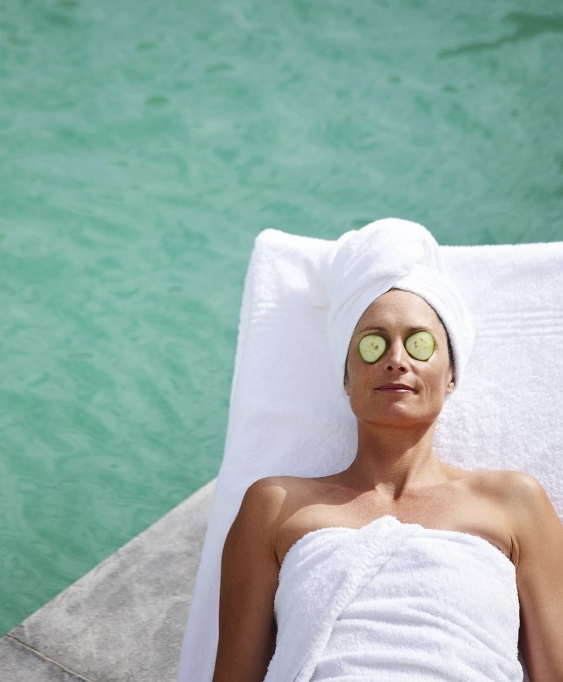 Woman relaxing by pool