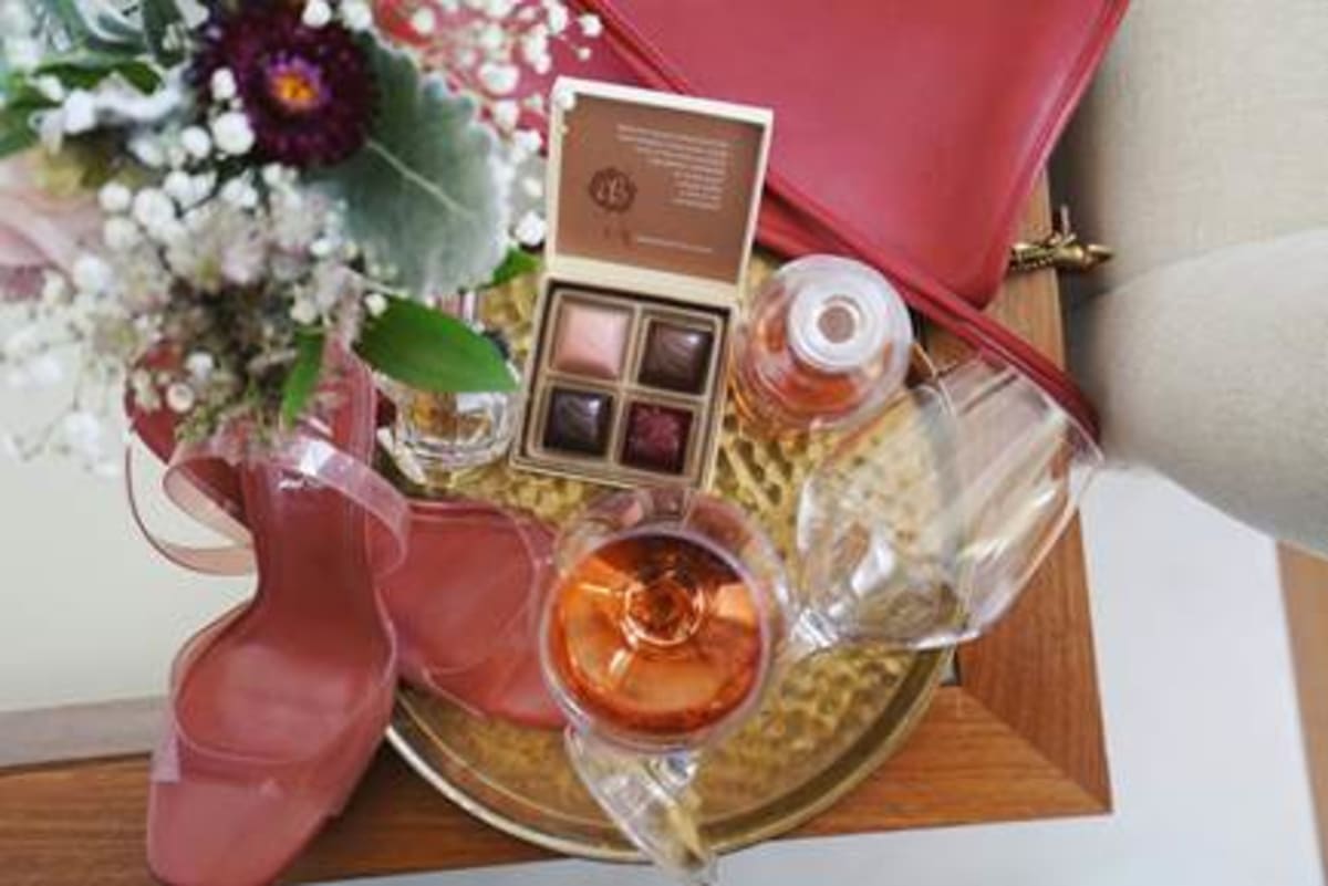 Chocolates, wine and flowers on table