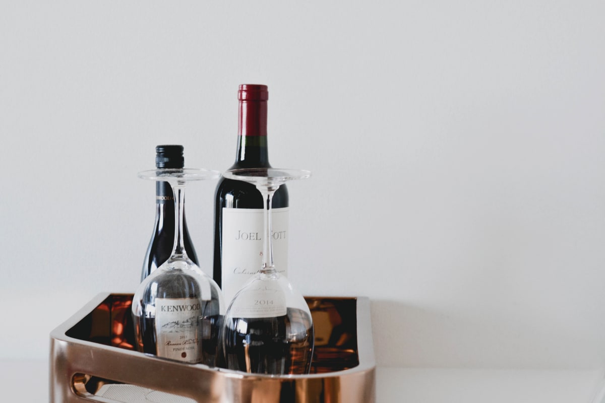 Two bottles of wine with wine glasses on tray