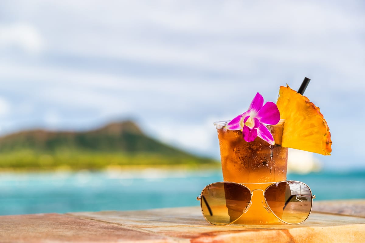 Tropical beverage in foreground with Diamond Head in background