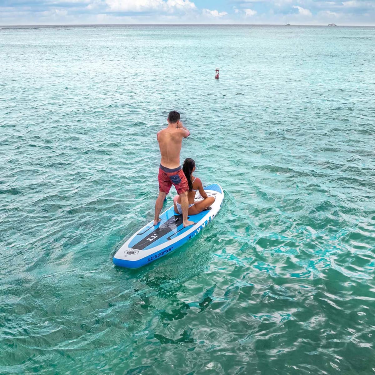 Guy and Girl on Standup Paddleboard on ocean