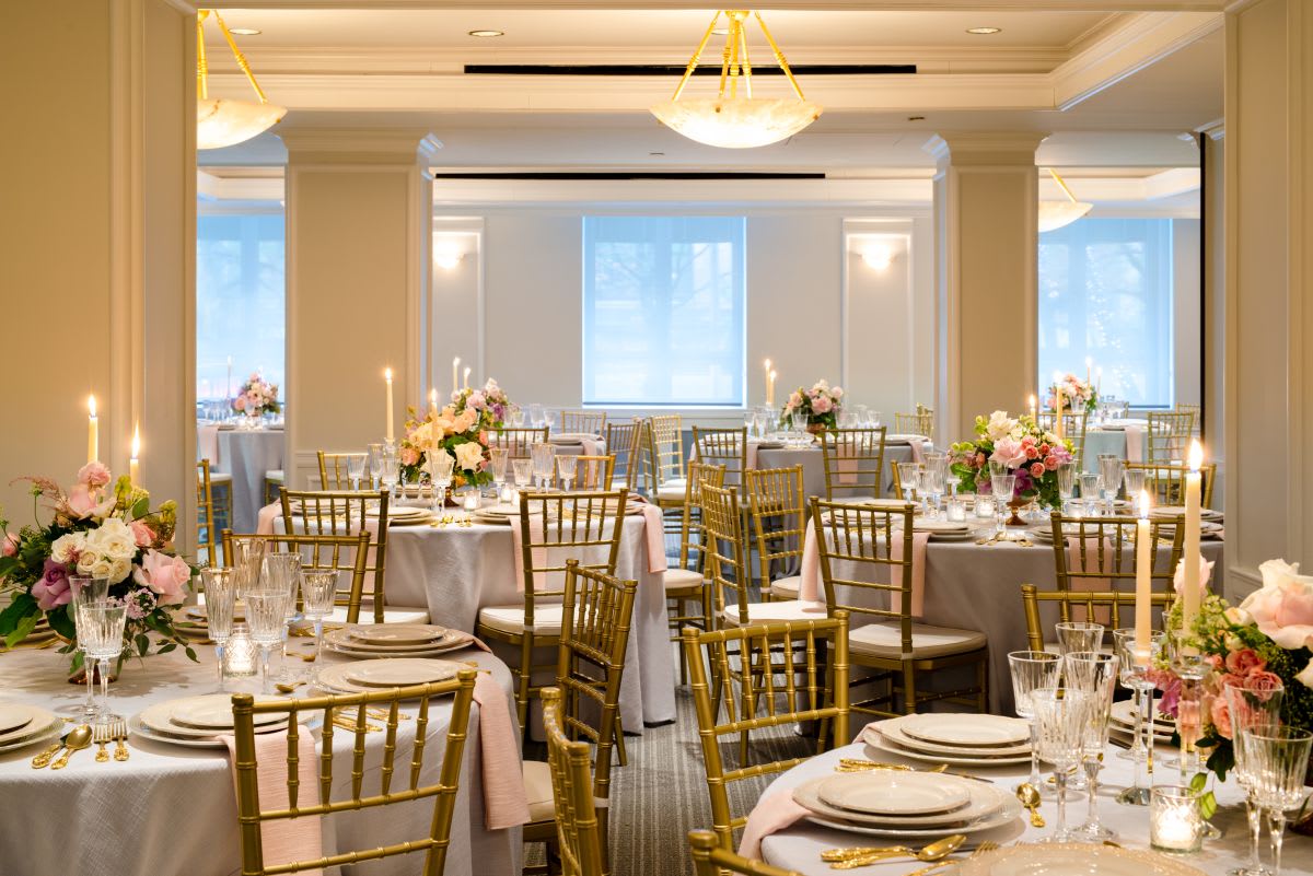 Broadway Amsterdam Room at Hotel Beacon New York, room dressed for wedding with seven round tables and center pieces with flowers and candles.