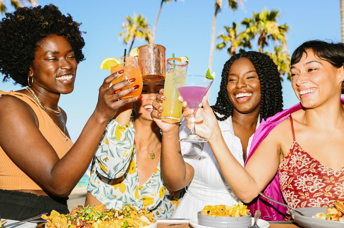 Girls toasting cocktails at Naughty Fox