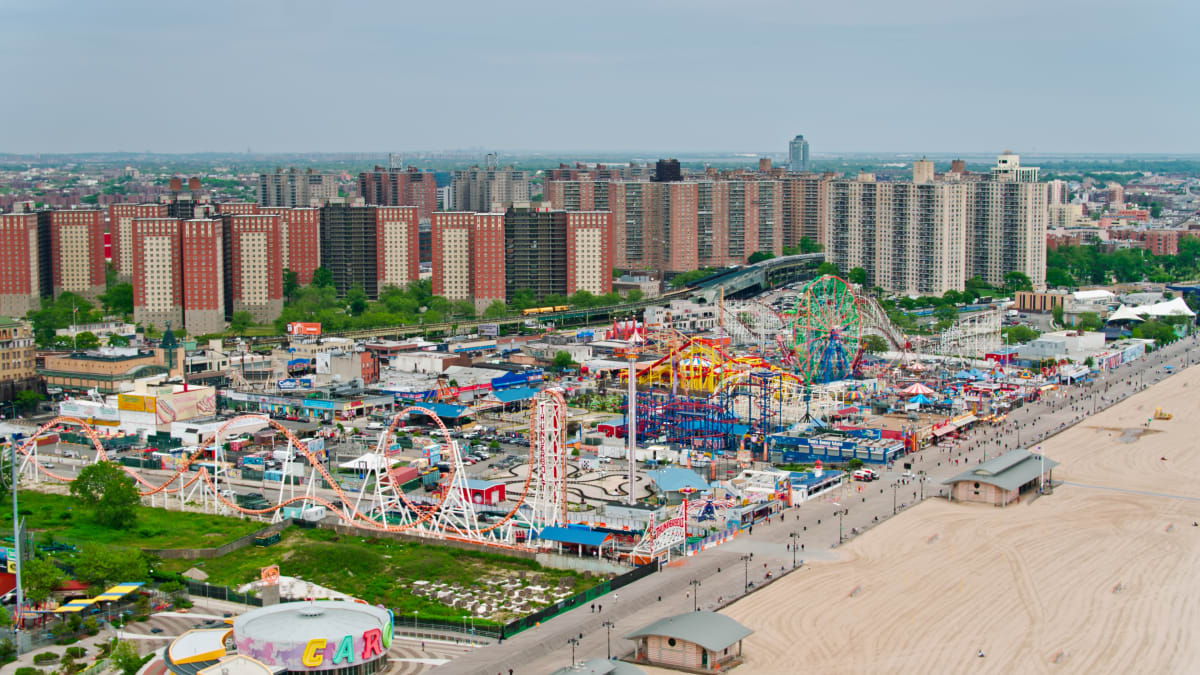 Drone photo of Coney Island and Luna Park, showing the various rides and attractions with skyscrapers in the background. 