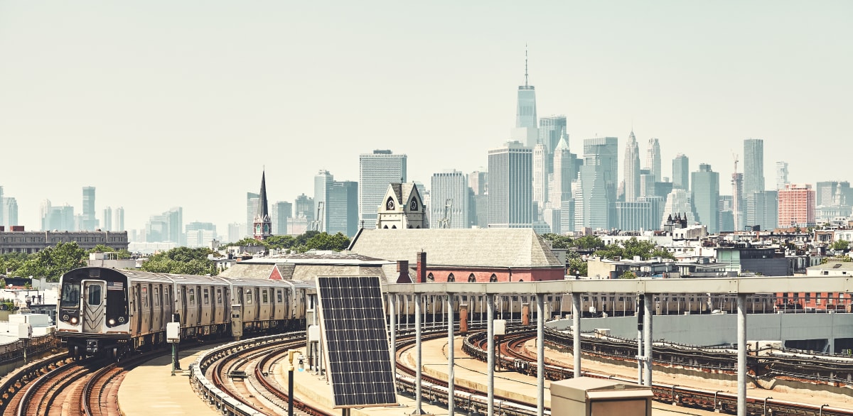 Train approaching platform at Smith and 9th with Manhattan in the background