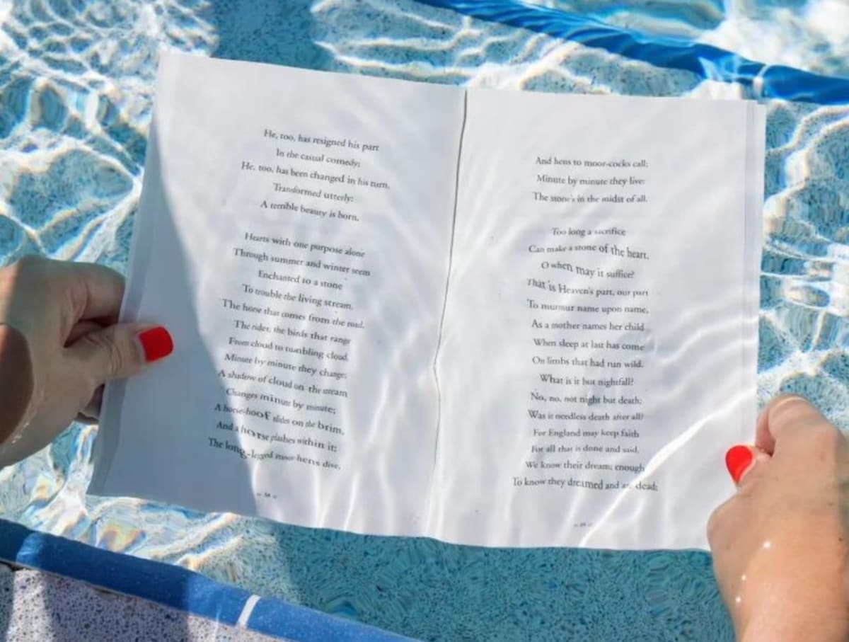 hands-holding-open-waterproof-book-underwater