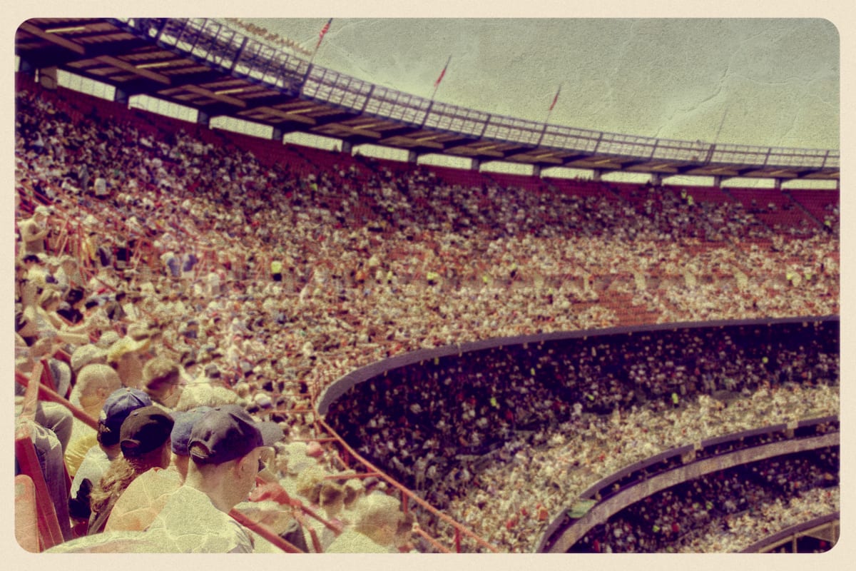 Aged postcard or photo of the inside of the original Yankee stadium, with the stands full of people 