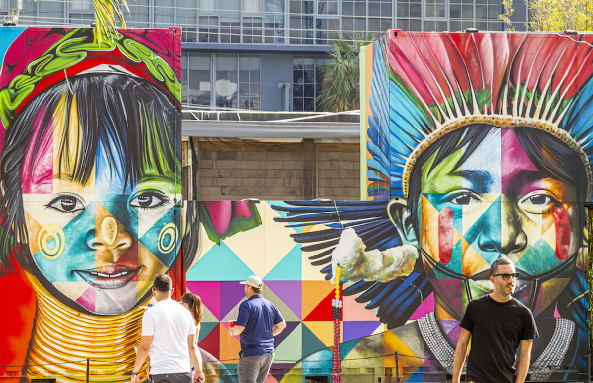 people-standing-in-front-of-colorful-mural-in-wynwood