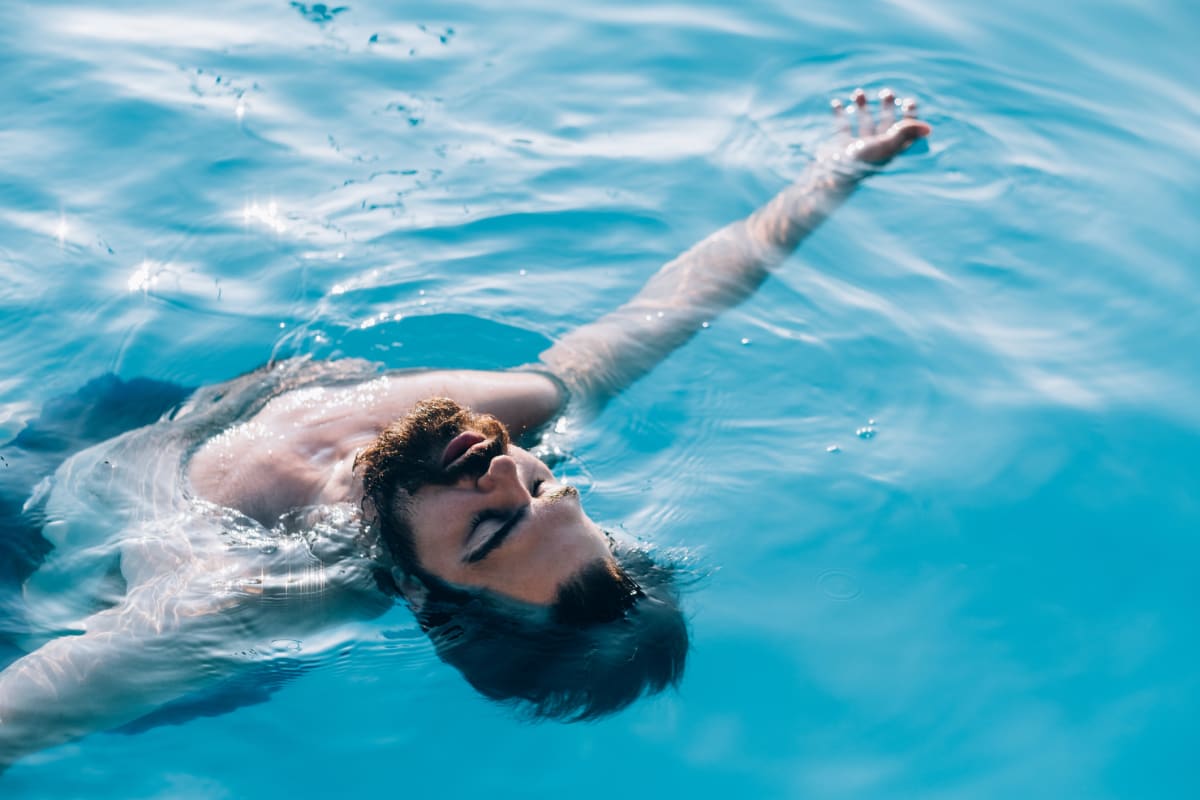 Man floats on his back in pool 