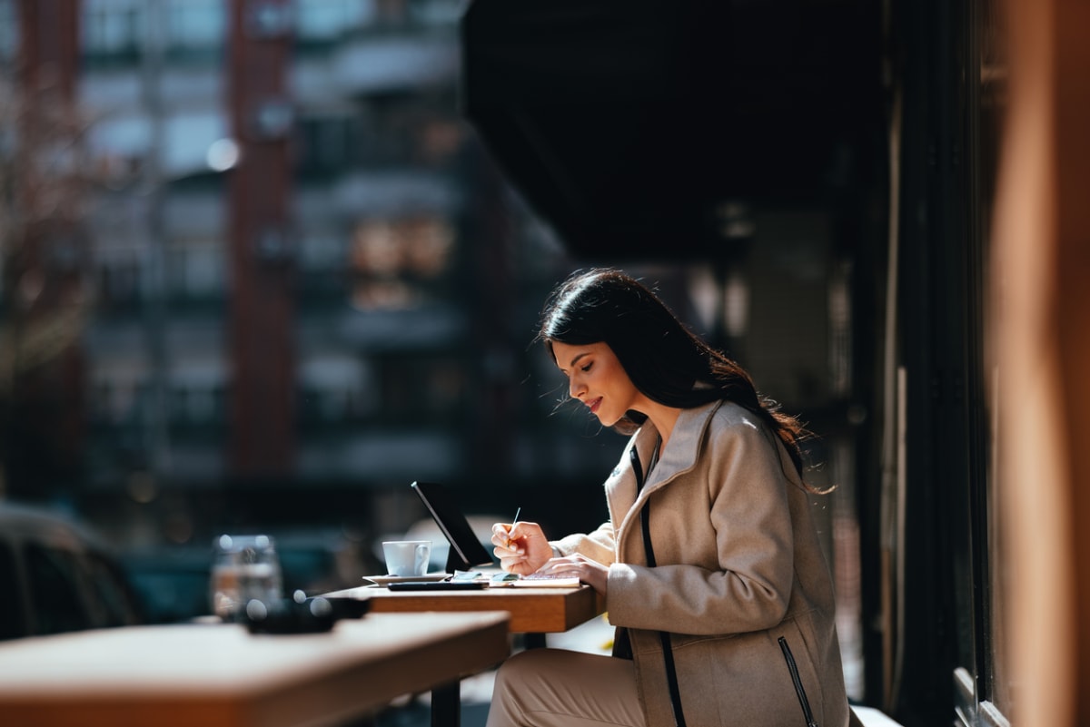 woman works from laptop in the sun 