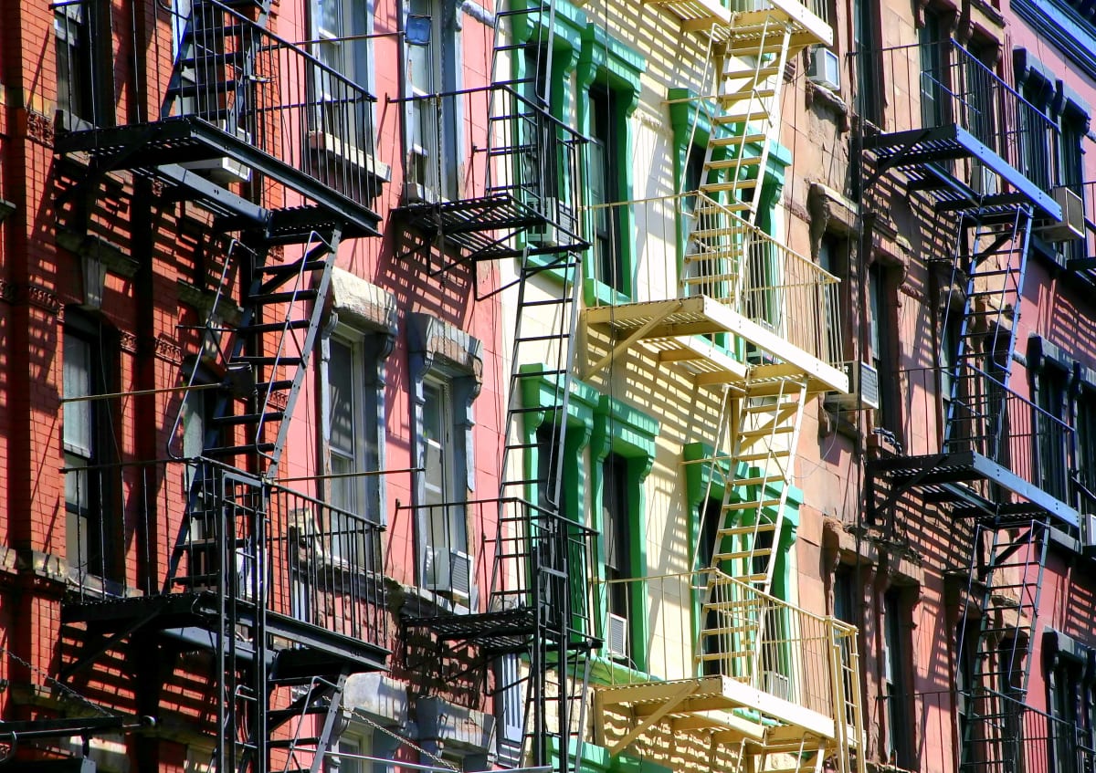 Multi coloured houses with painted balconies and fire escapes 