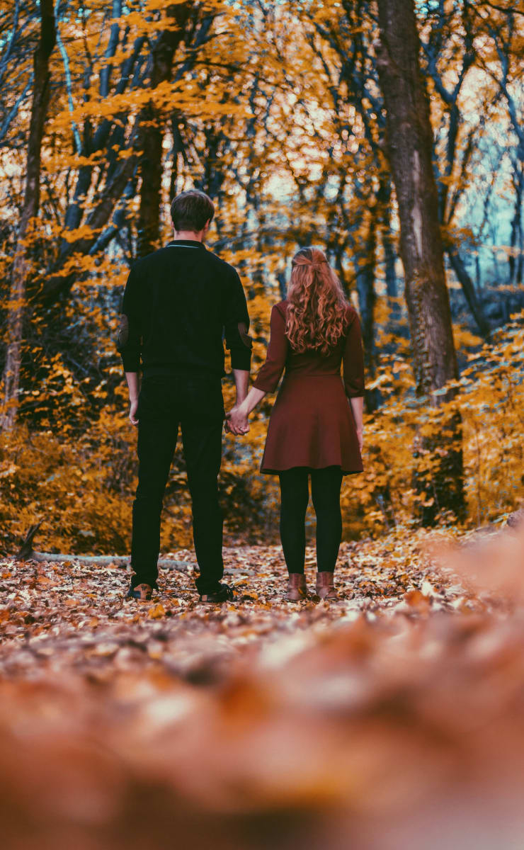 couple in fall coloured forest 