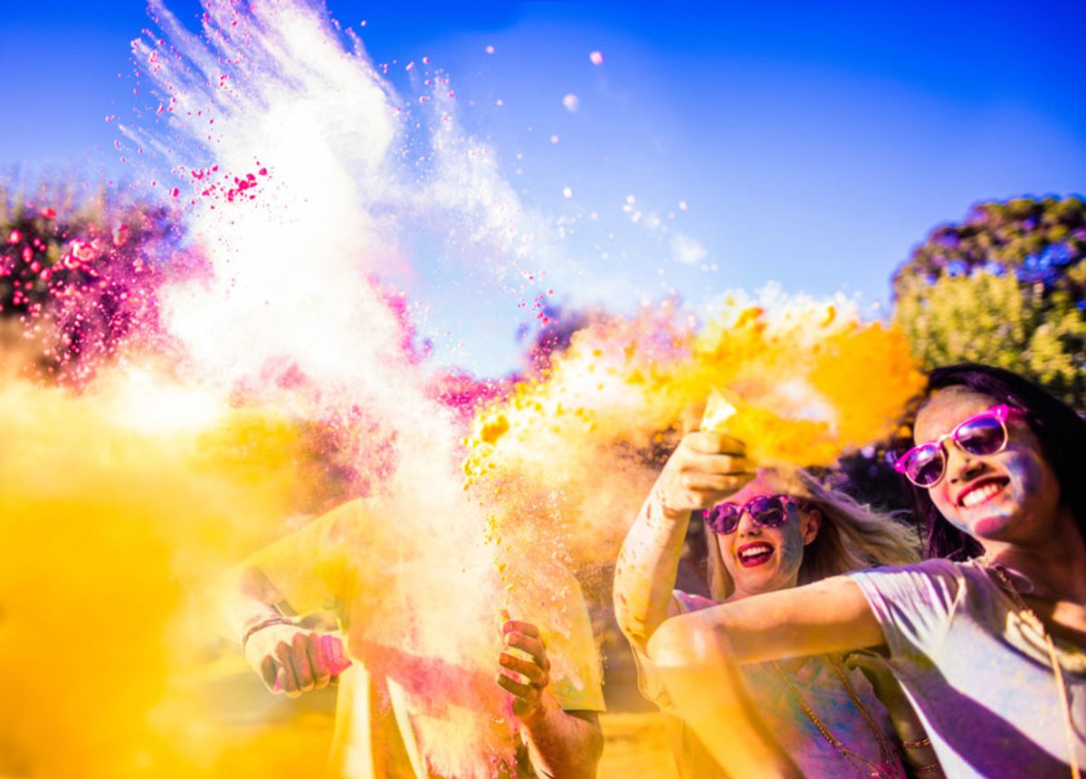 group-of-people-throwing-colored-powder