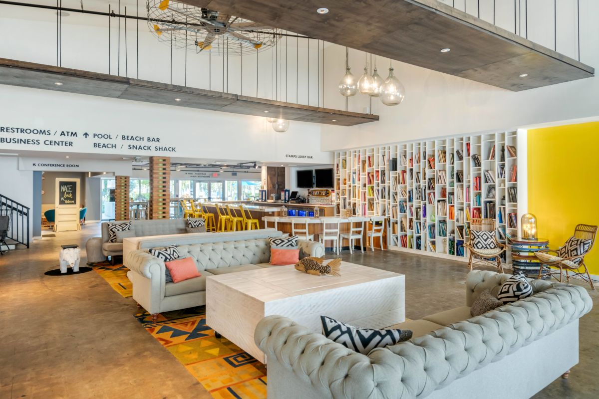 Postcard Inn Lobby with seating area and book shelf