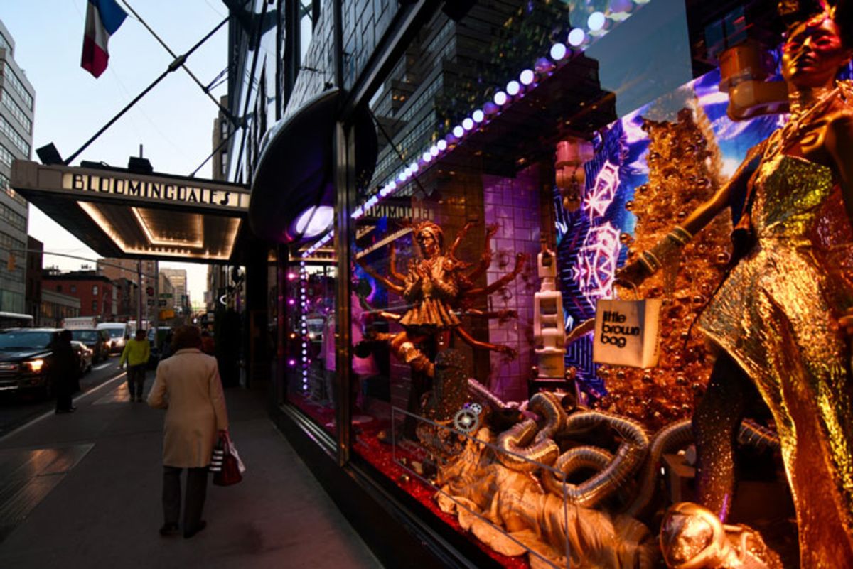 People walking in front of Holiday window display.