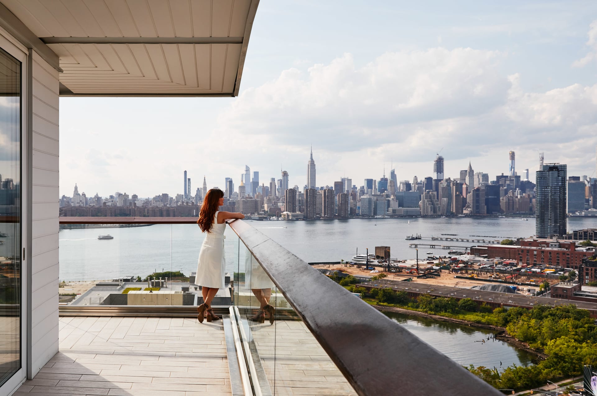 Gotham Corner Suite, woman enjoying the city view from the balcony