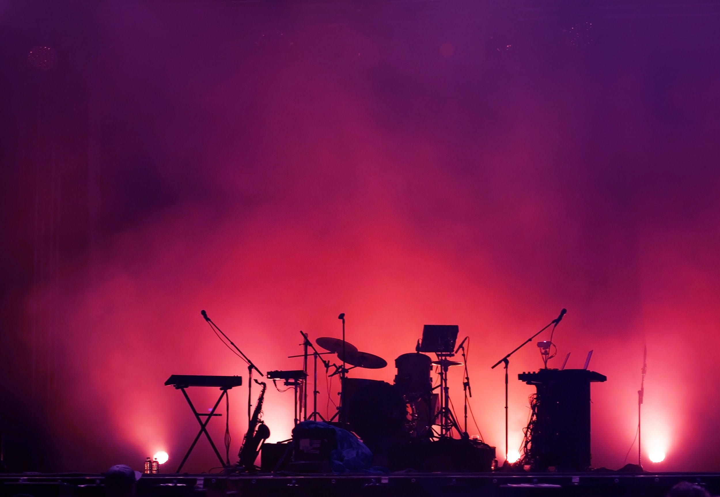 Band and music equipment on stage with smoke and studio lights in the background