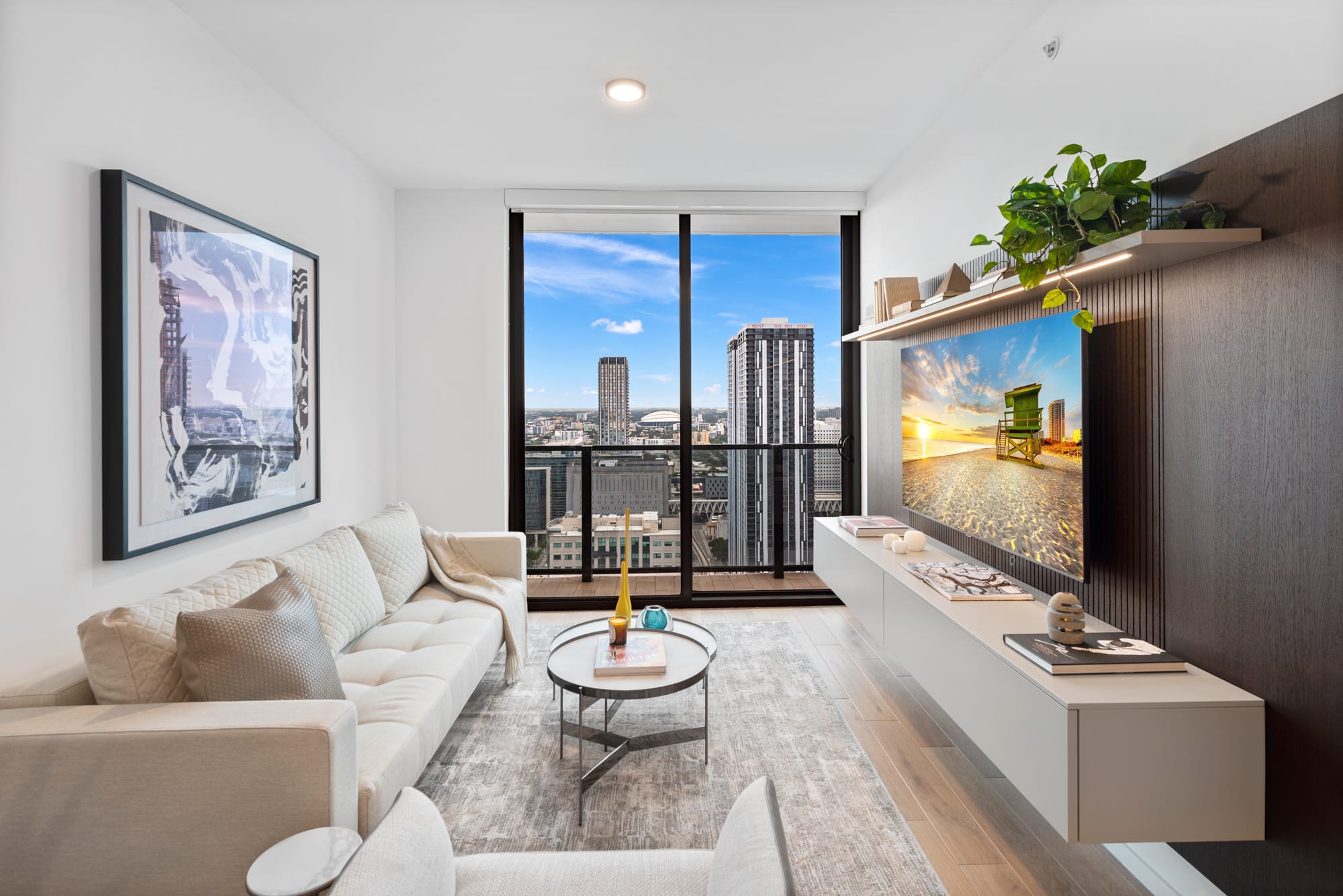 City View One Bedroom Suite at The Elser Hotel Miami featuring modern living room, skyline view, and smart TV with built-in entertainment wall