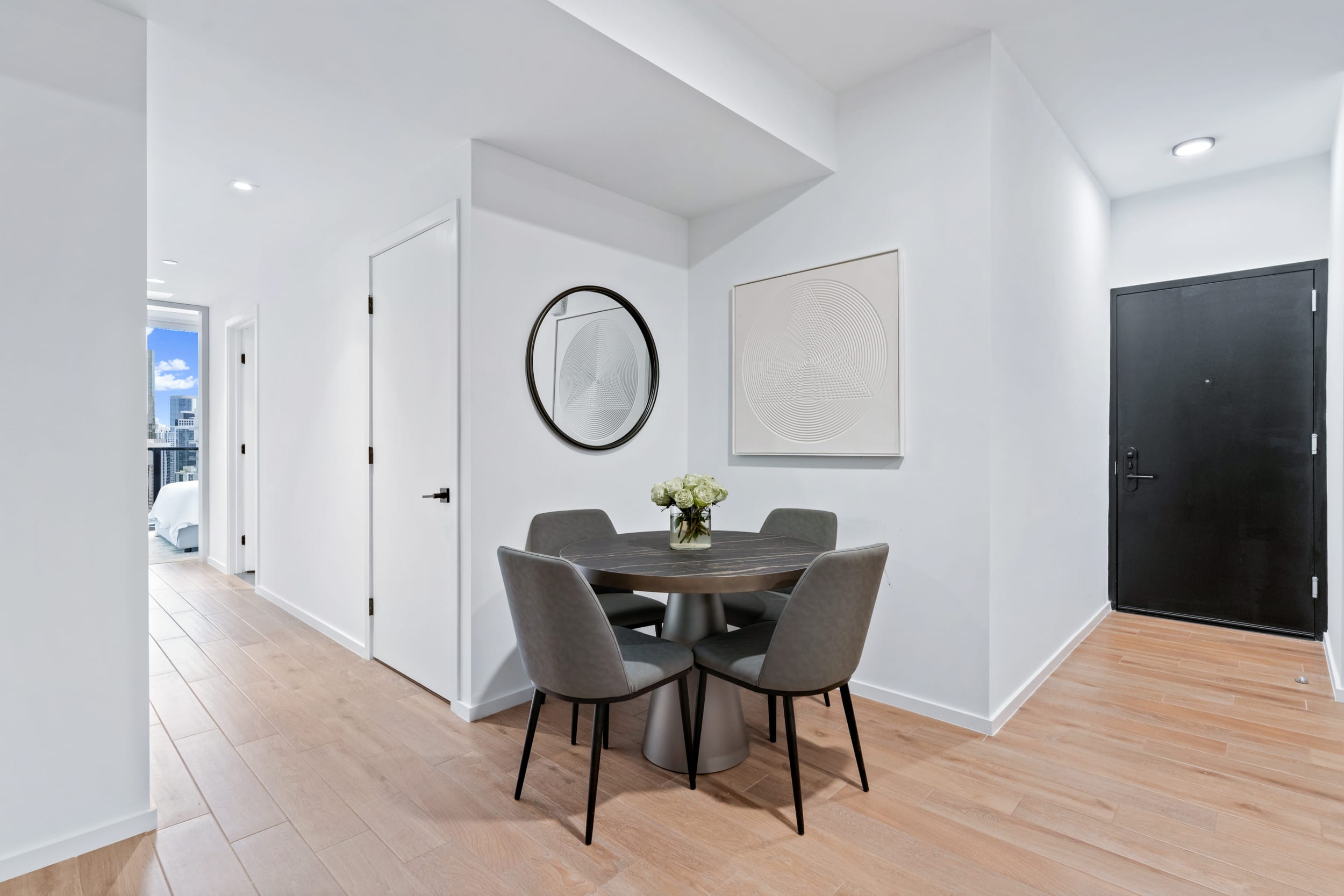 Entryway and dining nook in Bay View One Bedroom Suite at The Elser Hotel Miami with coastal-modern design and hardwood flooring