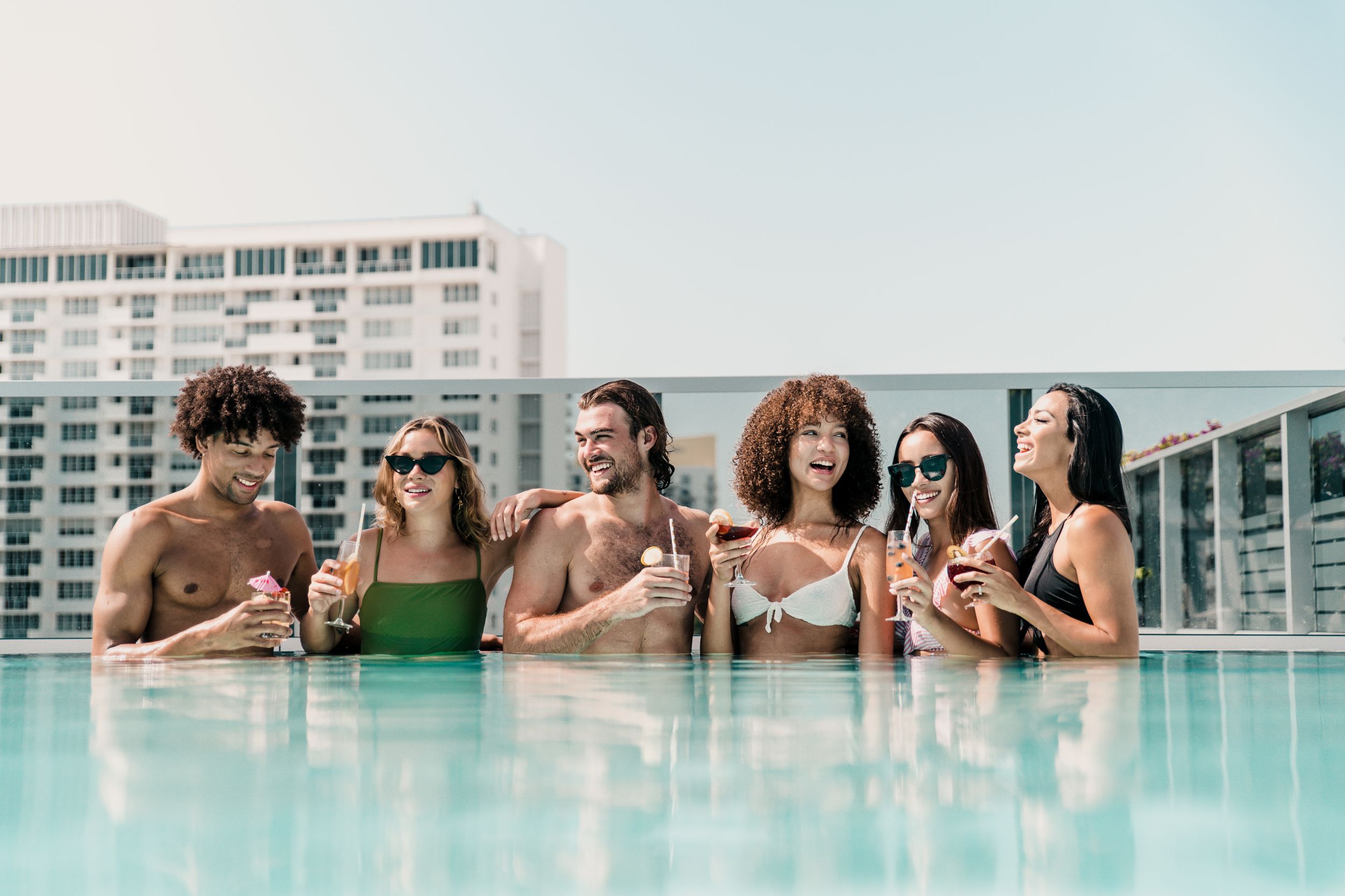 group in pool with drinks 