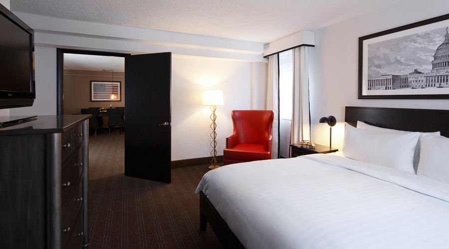 One bedroom room with bed looking into living area