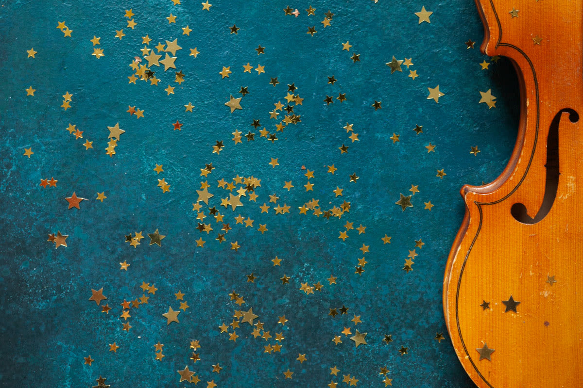 Violin with gold stars on a blue background