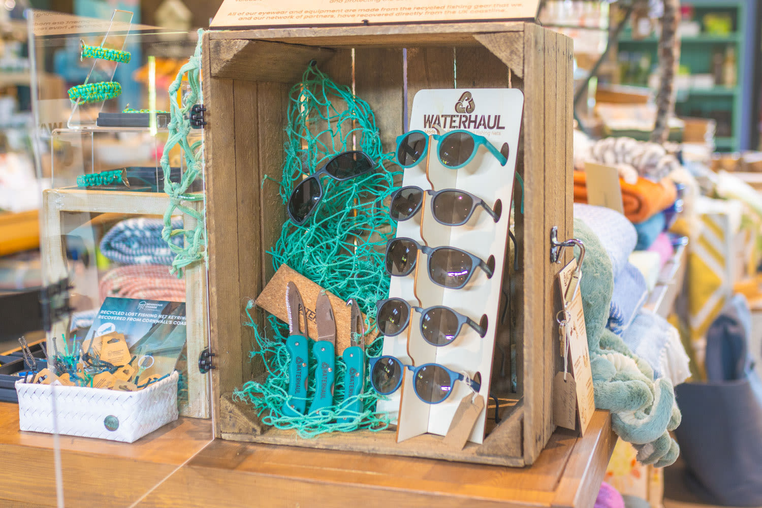 Waterhaul sunglasses and knives in a display case