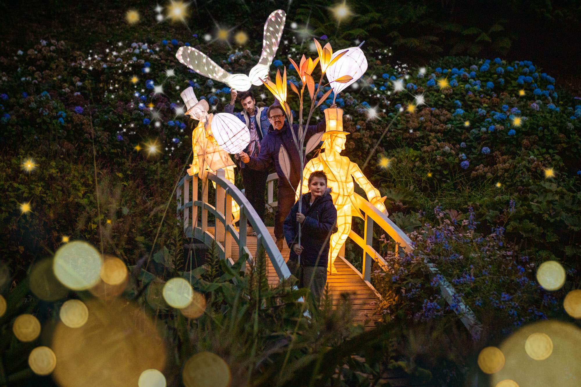 People holding lantern on Trebah bridge