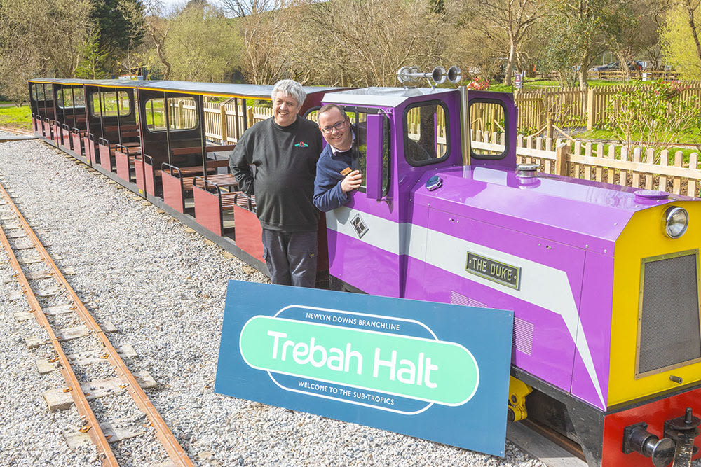 Trebah CEO Jon Cummins and lappa Valley owner  in a train next to the Trebah halt station sign at lappa valley