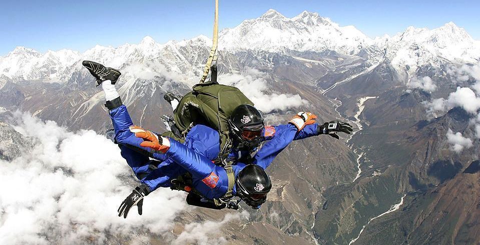 Tom Noonan of the US and Ganesh Pandey of Nepal perform a tandem skydive at an area near the world’s highest peak, Mount Everest, in Nepal