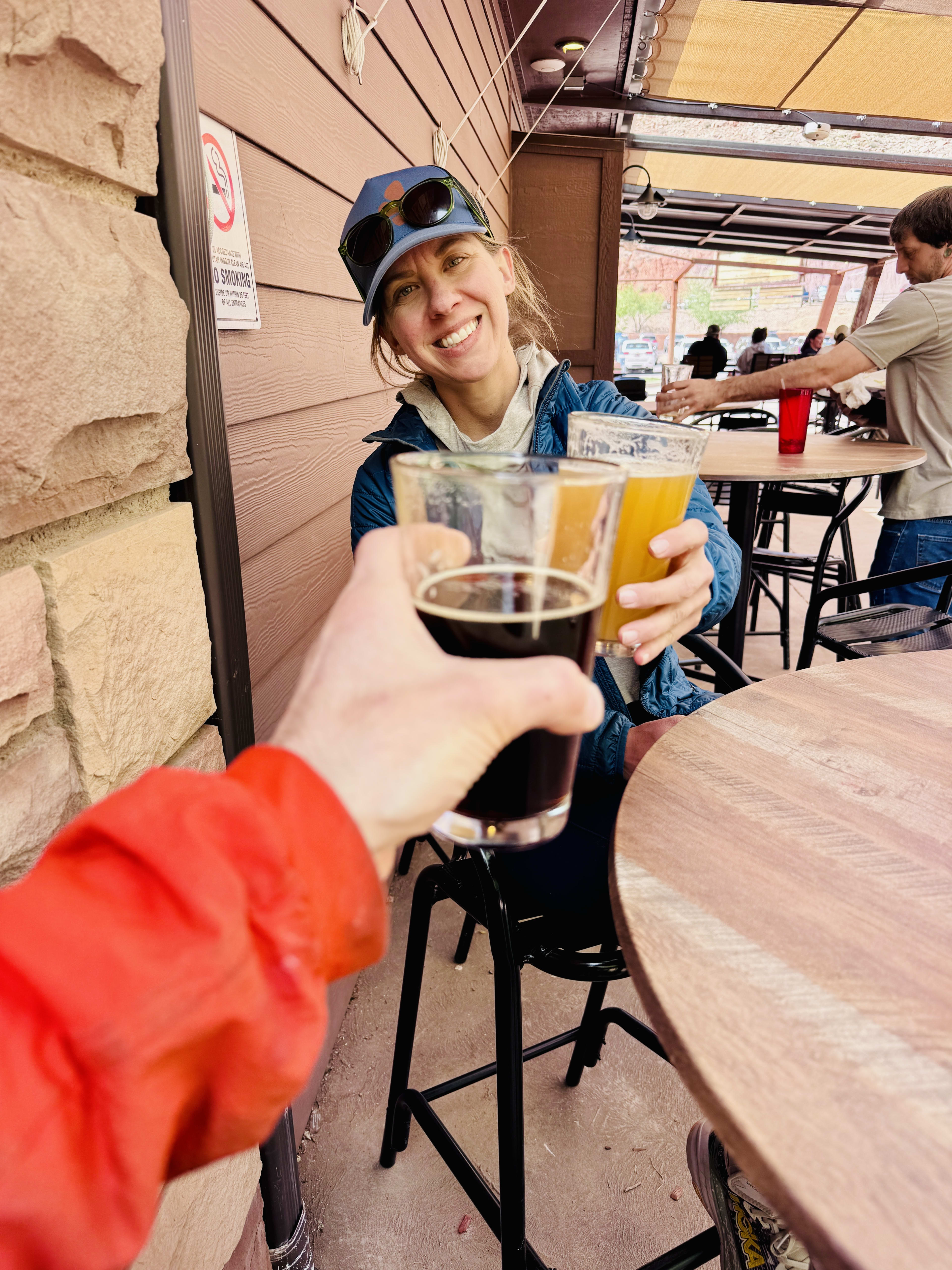 Bret and Bricelyn clinking glasses at a brewery in Zion
