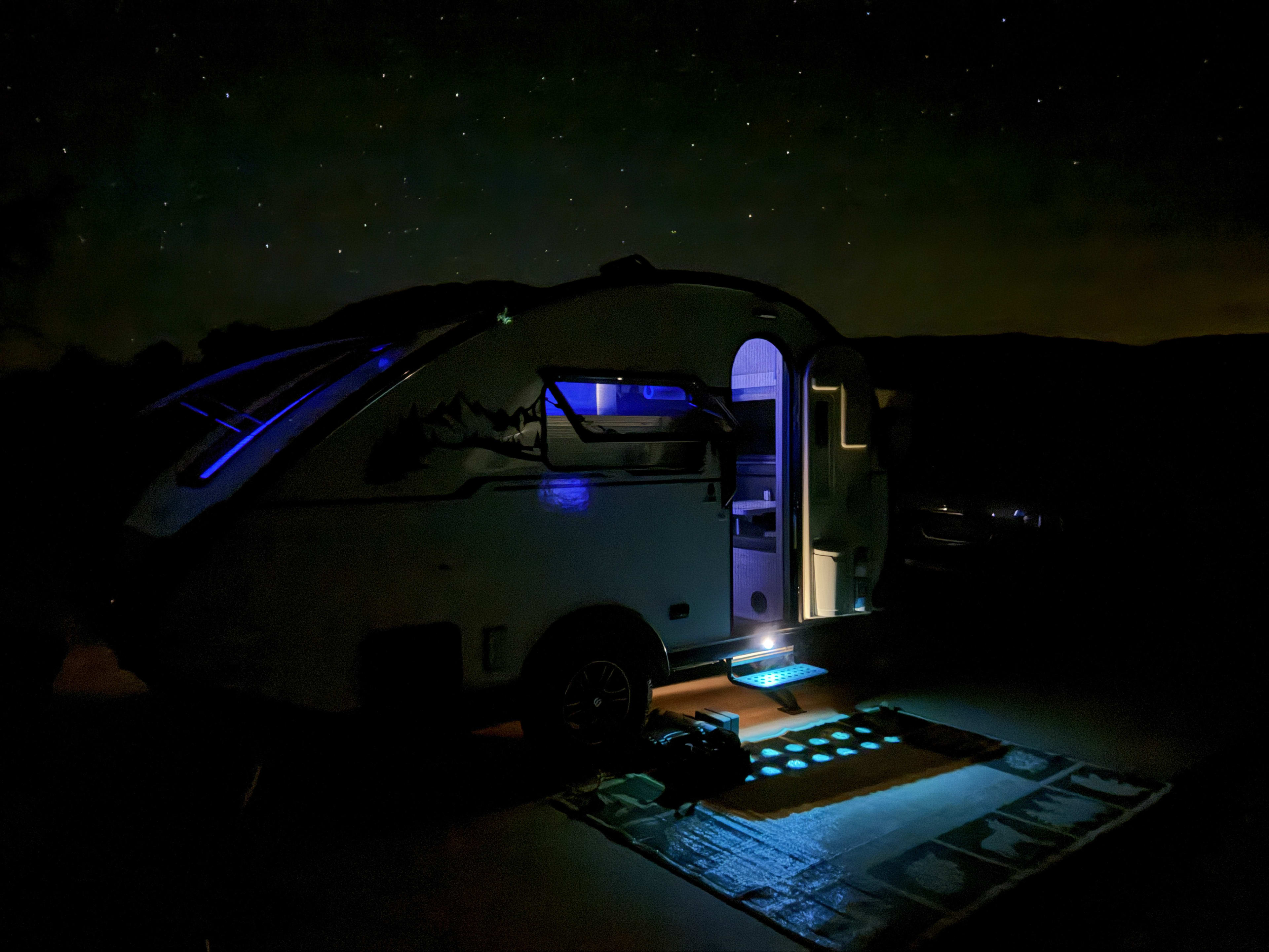 Inside the camper at night, blue LEDs glowing