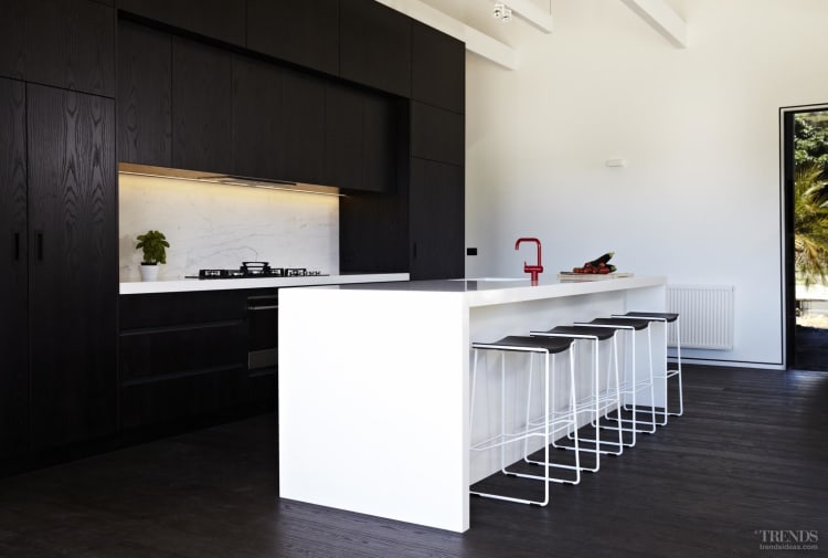 Contemporary black and white kitchen with dark-stained ...