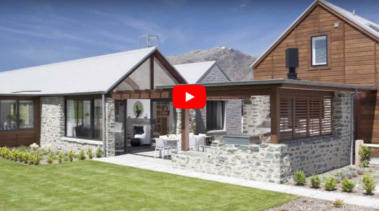 Central Otago style cottage open to the landscape featuring gabled pavilions and stone cladding