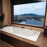 The view of a bath tub over looking bathroom, bathtub, interior design, plumbing fixture, room, window, black, white