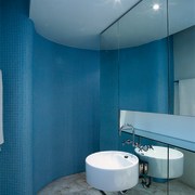 The view of an ensuite with a curved architecture, bathroom, blue, ceiling, daylighting, daytime, floor, glass, interior design, product design, room, tile, wall, teal, blue