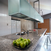 A granite benchtop under a glass storage unit architecture, countertop, house, interior design, kitchen, gray