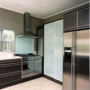 Looking at the cabinet sliding doors &amp; kitchen cabinetry, countertop, cuisine classique, floor, home appliance, interior design, kitchen, real estate, room, gray, black