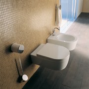 Bathroom: toilet and bidet cantilevered out from sandy angle, bathroom, bathroom sink, bidet, ceramic, floor, plumbing fixture, product, product design, sink, tap, tile, toilet, toilet seat, brown