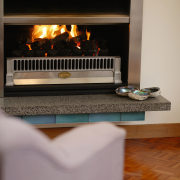 Gas fire with stainless steel surround, and stone fireplace, hearth, gray