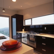 Kitchen with stainless steel ovens and gas cooktop, countertop, interior design, kitchen, real estate, black, brown