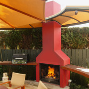 Outdoor living area with red open fireplace and backyard, home, outdoor structure, patio, brown, orange