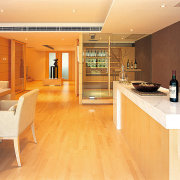 A view of the dining area with a cabinetry, countertop, floor, flooring, interior design, kitchen, real estate, room, wood, wood flooring, orange, brown