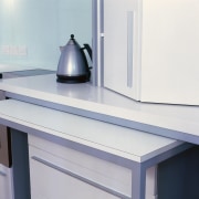 Kitchen with white benchtop and cabinetry, and pull-out countertop, furniture, product design, table, gray, white