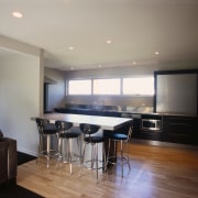 Kitchen with cream walls, wooden floors, black cabinetry, ceiling, floor, interior design, kitchen, property, real estate, room, gray, black