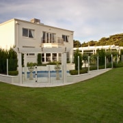 View of the backyard of this home - architecture, estate, facade, grass, home, house, mansion, property, real estate, residential area, villa, brown, gray