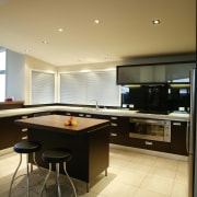 Kitchen with brown cabinetry and white benchtop with billiard room, ceiling, countertop, floor, flooring, interior design, kitchen, recreation room, room, table, brown