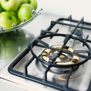 Gas hob cooktop set on textured stainless steel product design, white